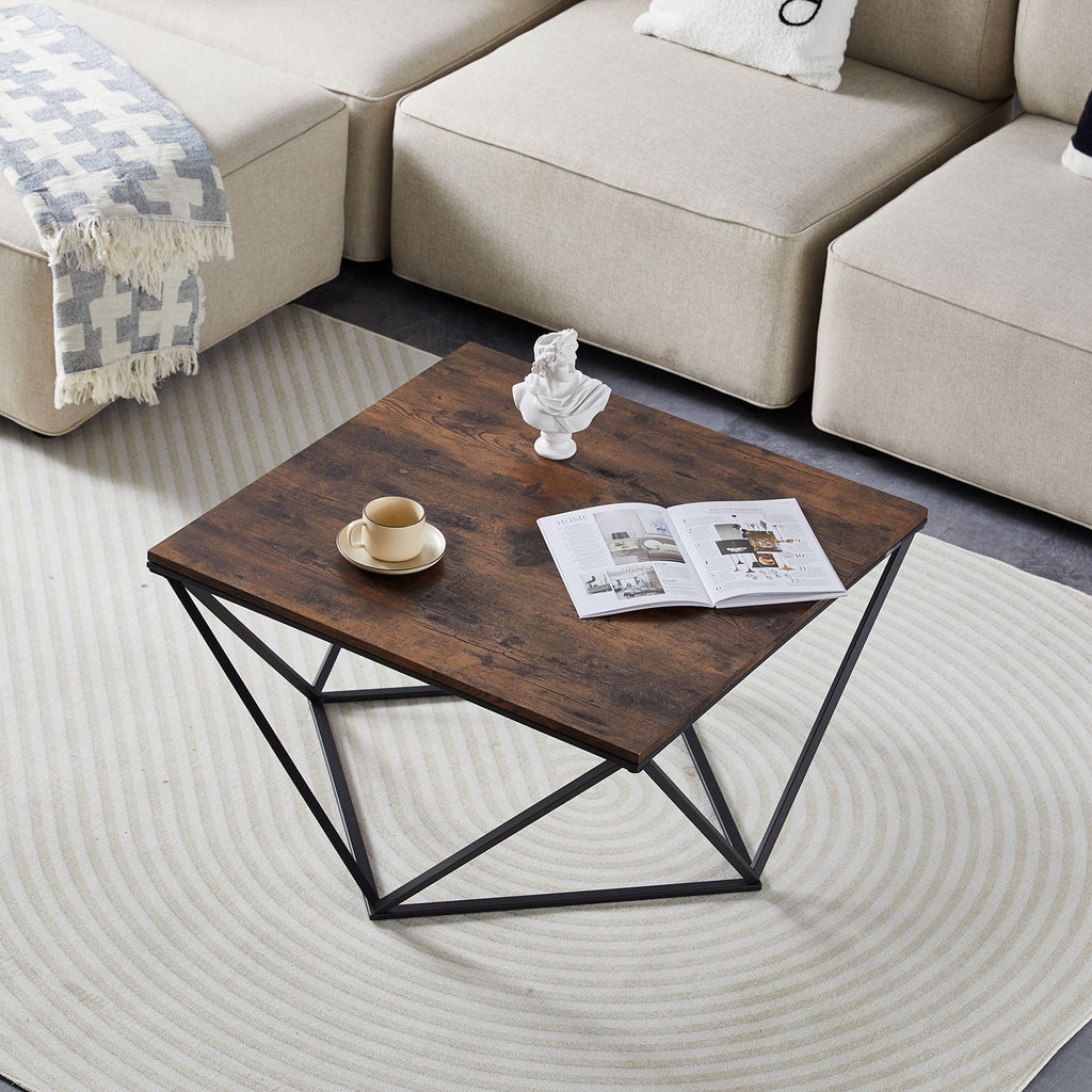 Wooden coffee table with a magazine and cup in a living room setting